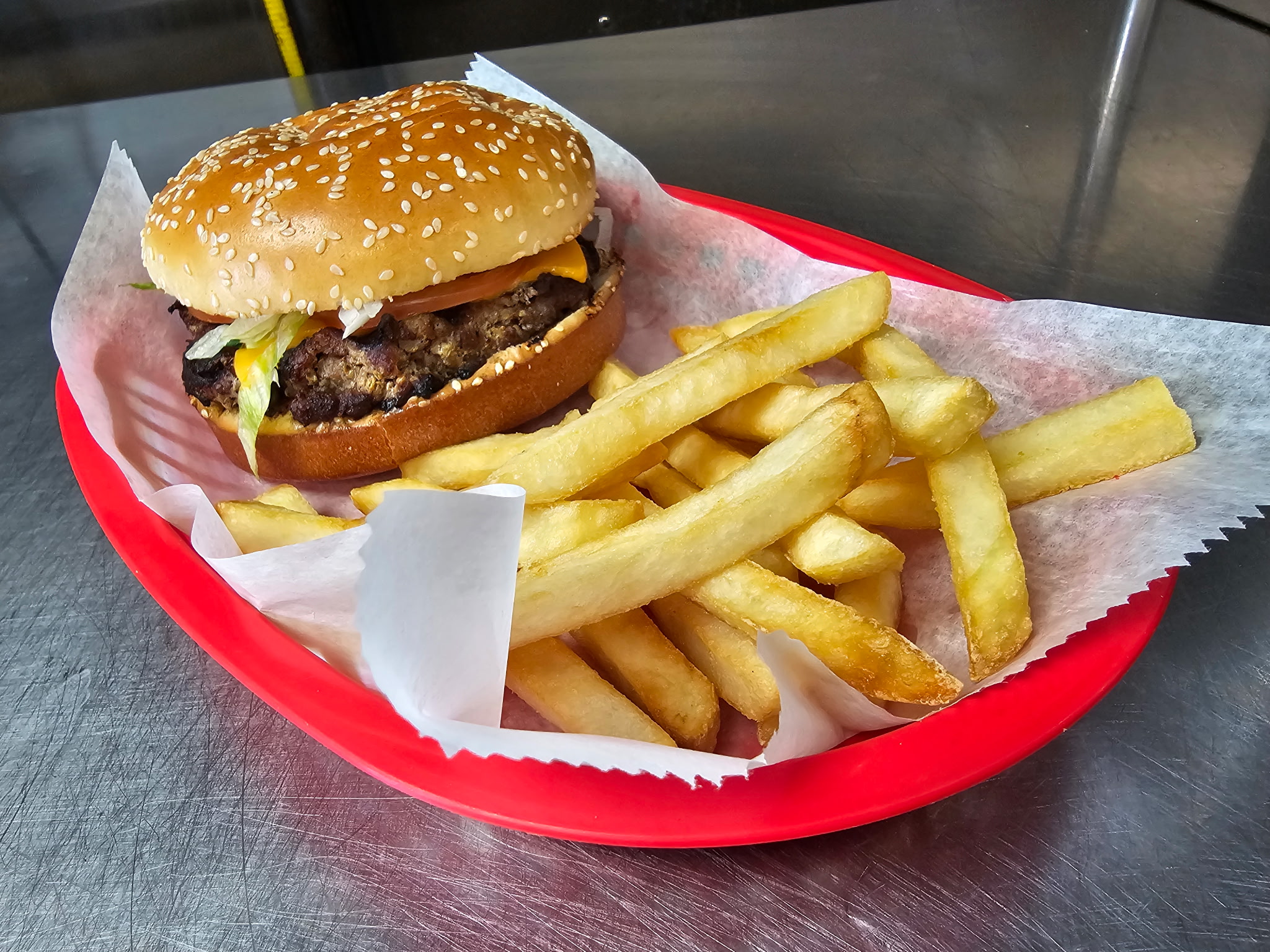 Charcoal-grilled burger with fries at Emily's Bar and Grill