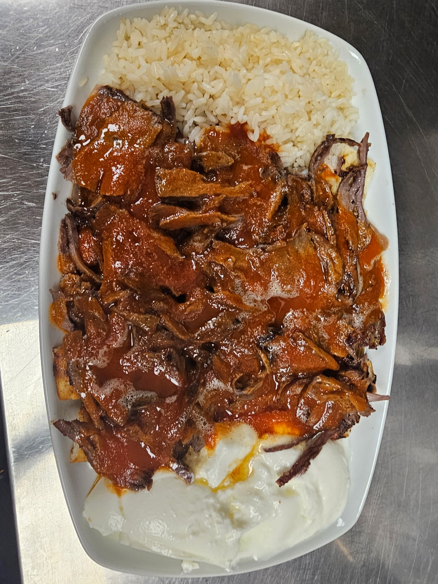 Iskender kebab with warm tomato sauce, yogurt and melted butter at Emily's