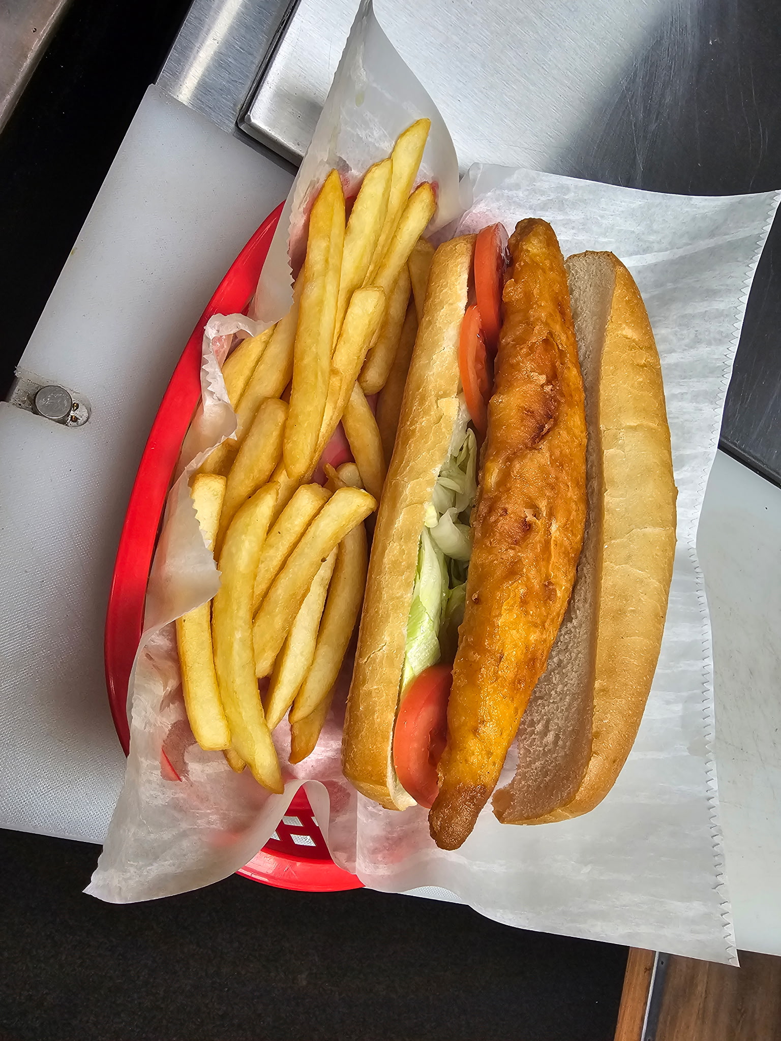 Crispy fish sub sandwich with fries
